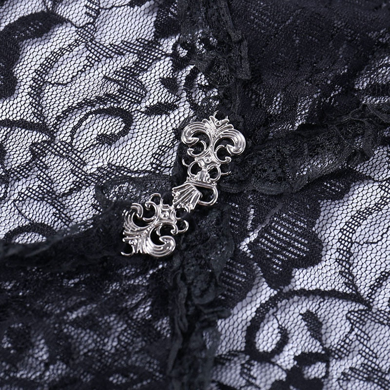Macro view of the decorative silver-tone clasp joining the black floral lace bolero at the front.