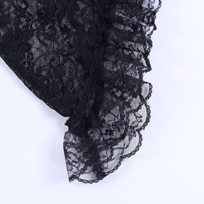 Ruffled black lace edging photographed closely along the overlay's flared sleeve.