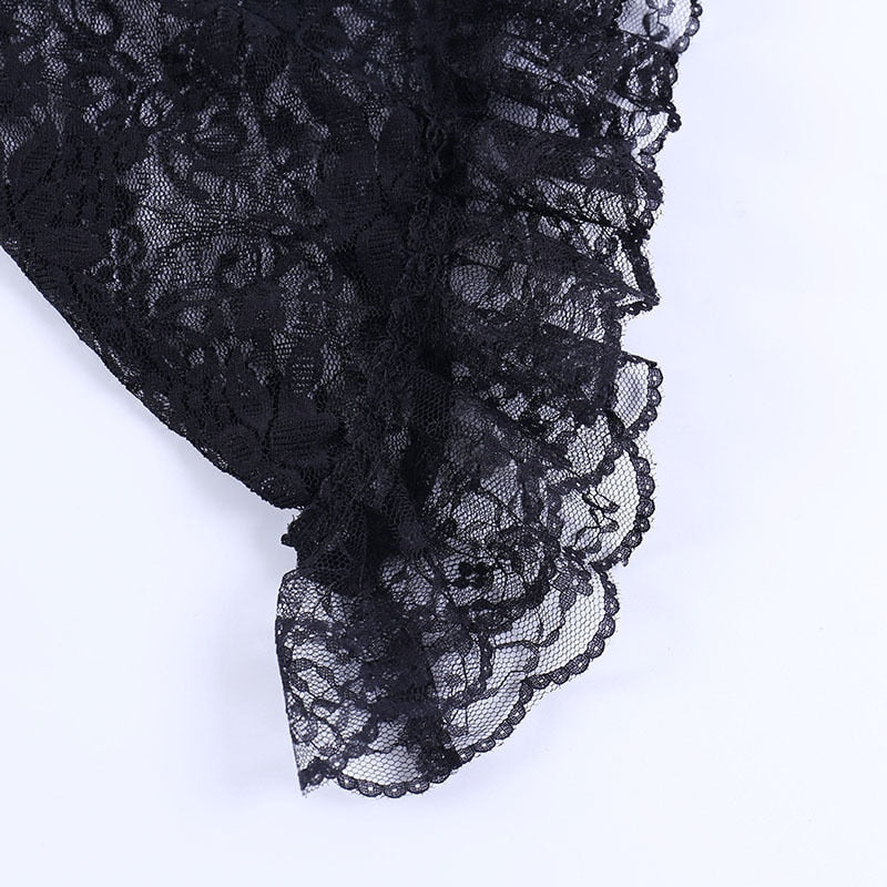 Ruffled black lace edging photographed closely along the overlay's flared sleeve.