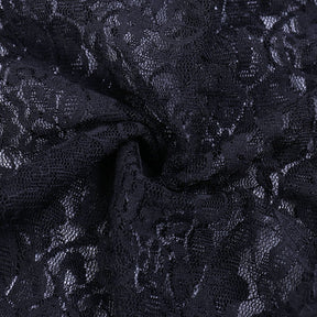 Close-up of folded black floral lace from the bolero, showing the fine mesh and flower motifs.
