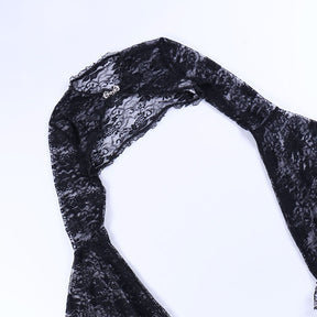 Black floral lace overlay laid flat on white, showing its shoulder seam and cropped back shape.