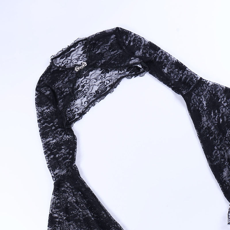 Black floral lace overlay laid flat on white, showing its shoulder seam and cropped back shape.