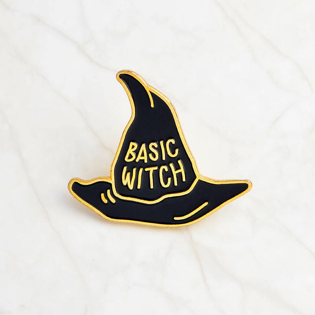 Black Basic Witch hat pin with gold-tone lettering, a pointed crown and a curved brim on white.