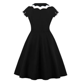 Back view of the black swing dress displayed alone, showing the contrasting collar and plain skirt.
