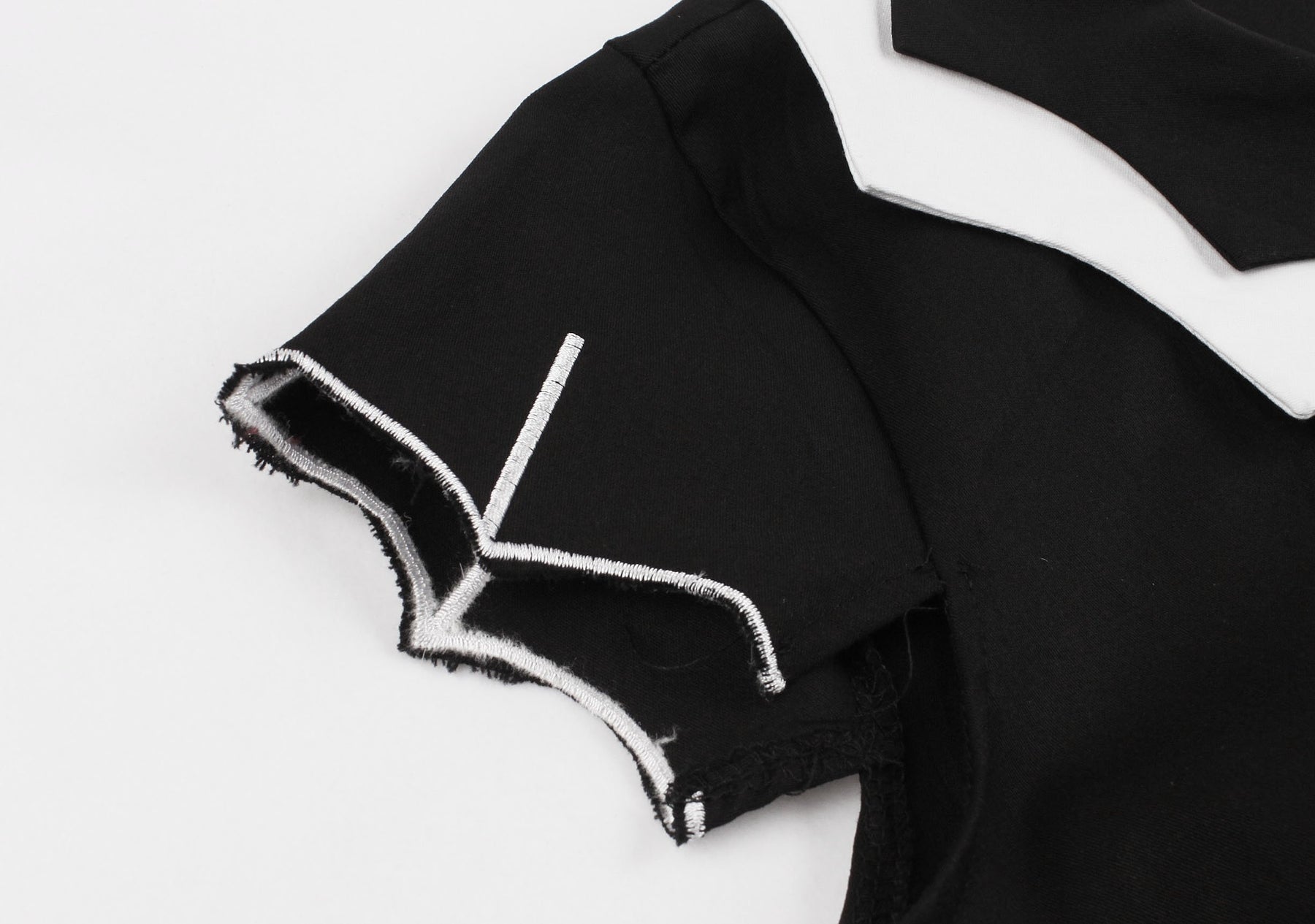 Close-up of the dress sleeve with a pointed bat-wing edge and white line detailing.