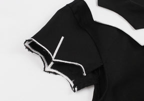 Close-up of the dress sleeve with a pointed bat-wing edge and white line detailing.