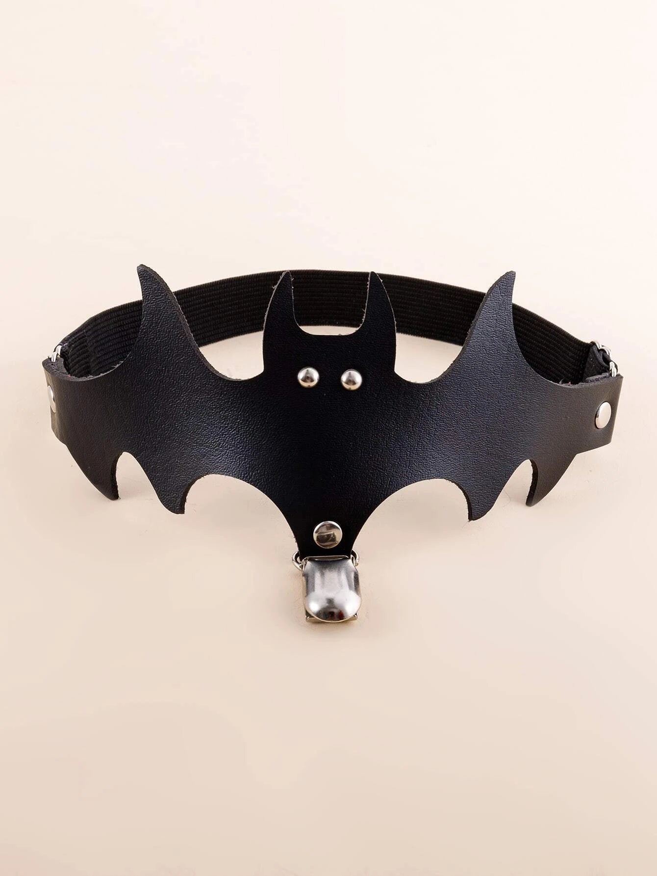 Black bat garter laid out with its narrow leg band and silver-tone clip beneath the bat silhouette.