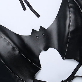 Close view of the black bralette’s bat face, with pointed ears and two tiny eye cutouts between stitched wings.
