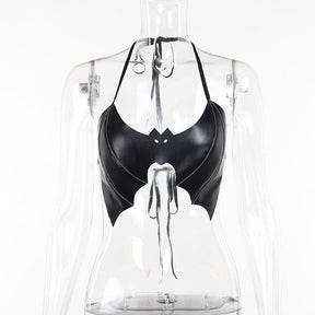 Black bat wing bralette displayed on a clear mannequin, with a tied halter neckline, eye cutouts and pointed scalloped wing edges.