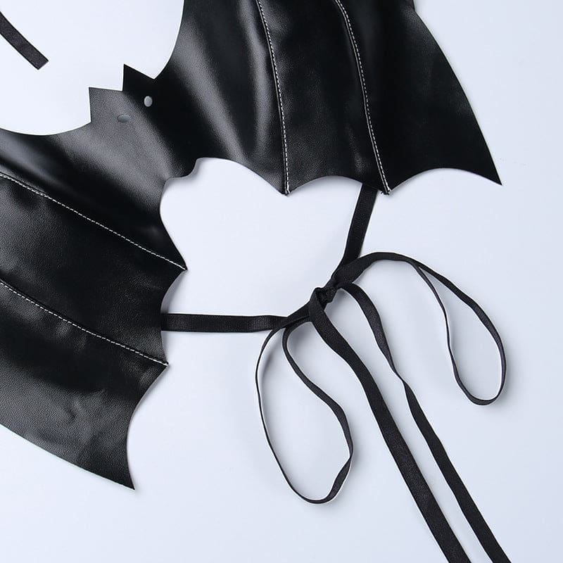 Black bat bralette laid flat to show the curved lower opening, wing stitching and thin straps tied in a bow.