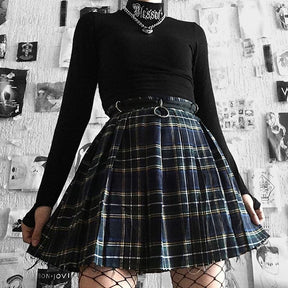 Black Blessed embroidered turtleneck crop top styled with a blue plaid skirt.