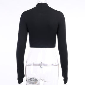 Black Blessed embroidered turtleneck crop top shown from the back on a mannequin.
