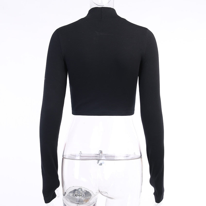 Black Blessed embroidered turtleneck crop top shown from the back on a mannequin.