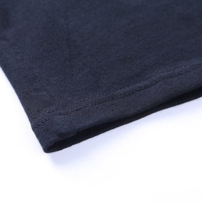 Black Blessed embroidered turtleneck crop top with a close view of the stitched hem.