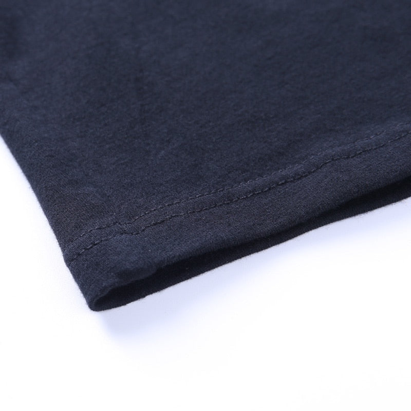 Black Blessed embroidered turtleneck crop top with a close view of the stitched hem.