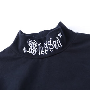 Black Blessed embroidered turtleneck crop top with a close view of the white Blessed collar embroidery.