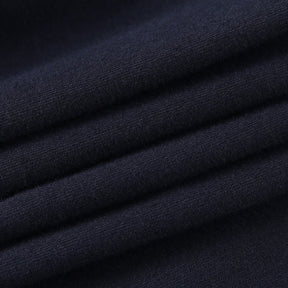 Black Blessed embroidered turtleneck crop top with a close view of the black fabric.