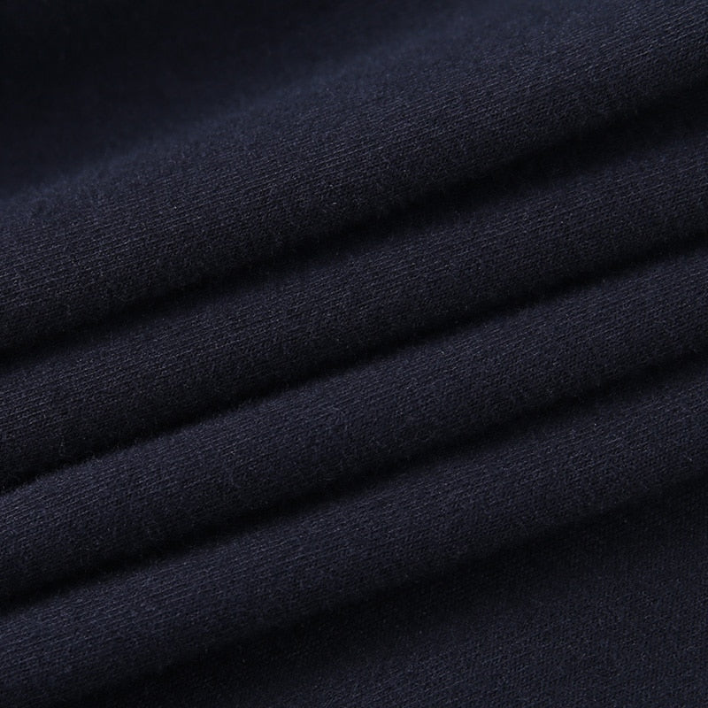 Black Blessed embroidered turtleneck crop top with a close view of the black fabric.