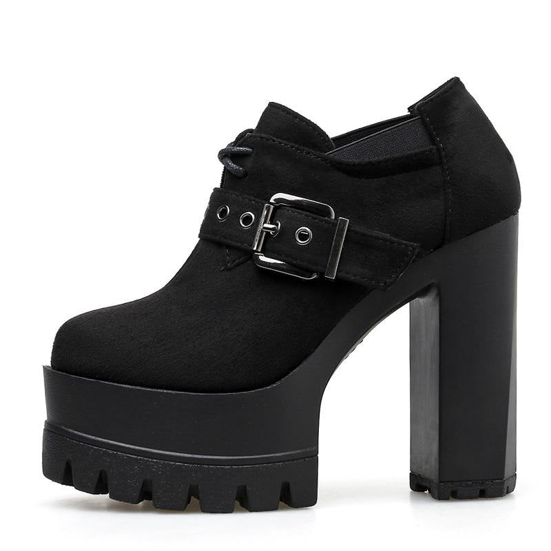 Side profile of a black lace-up buckle bootie with a rounded closed toe, deep front platform and tall block heel.