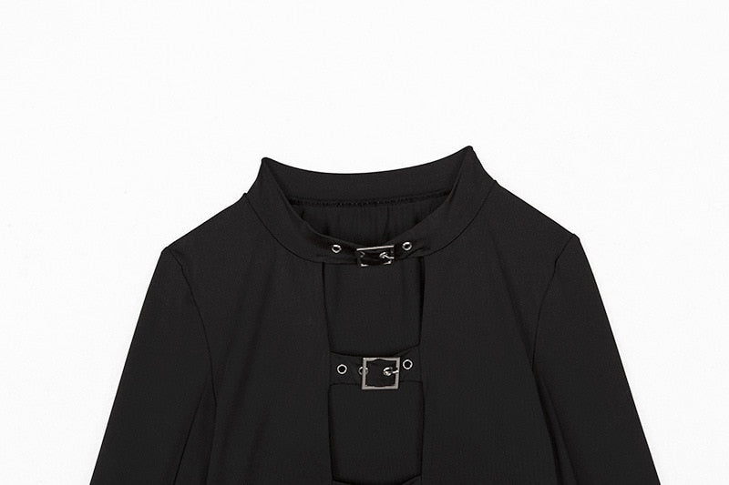 Upper front of the black crop top laid flat, showing the rounded neck band and two rectangular buckle fastenings.