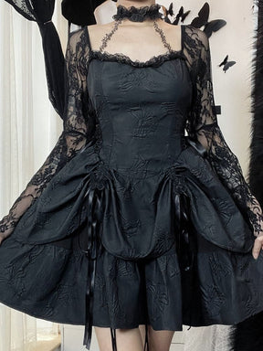 Black gothic dress modeled from the front with the arms lowered, showing the full shape of the long lace bell sleeves and the flared layered skirt.