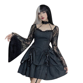 Black Dark Chapel dress modeled against a plain white background with a lace sleeve extended and the layered skirt spread to show its shape.