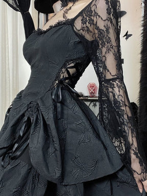 Angled side view of the black dress showing crisscrossed ribbon lacing over a lace inset at the waist. The long lace sleeve falls beside the layered skirt.