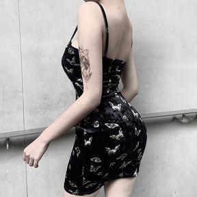 Black velvet butterfly-print mini dress worn from the back and side.