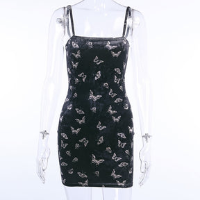 Black velvet butterfly-print mini dress displayed from the front on a clear mannequin.