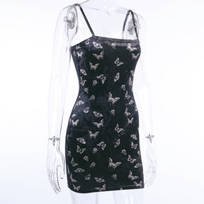 Black velvet butterfly-print mini dress displayed at an angle on a mannequin.