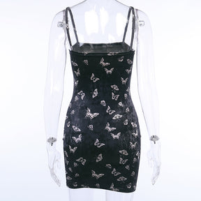 Black velvet butterfly-print mini dress displayed from the back on a mannequin.