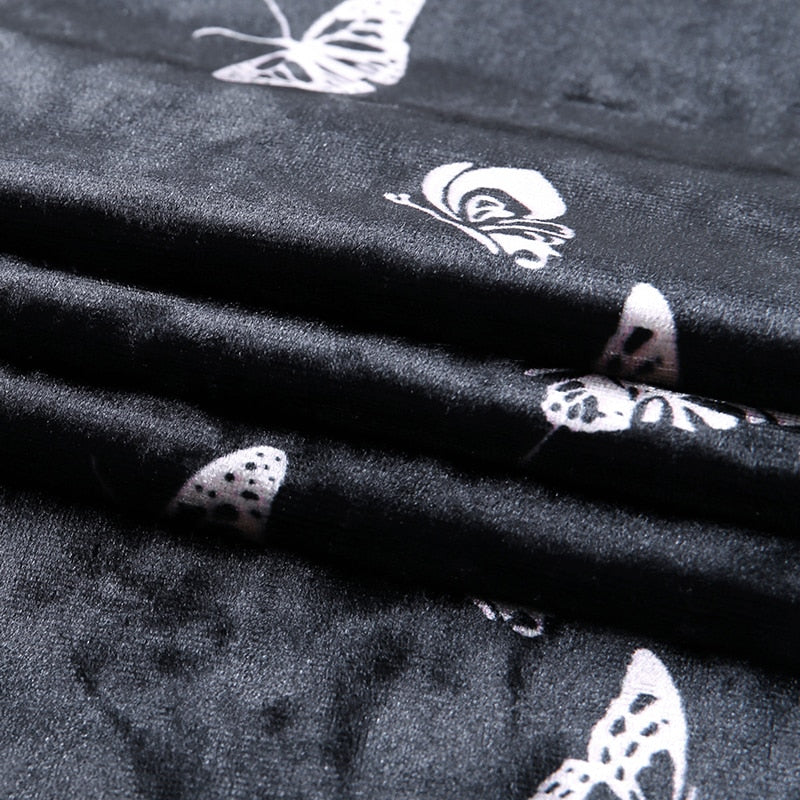 Black velvet butterfly-print mini dress with a close view of the silvery butterfly print and velvet texture.