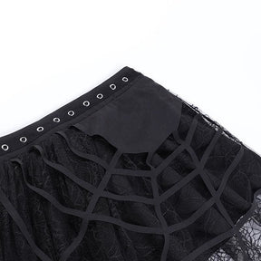 Diagonal flat-lay detail of the eyelet waistband and raised cutout webs on the black skirt.