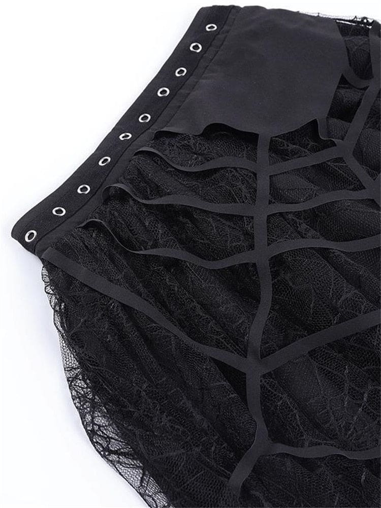 Close view of silver-tone waistband eyelets and the black cutout web overlay on the tutu skirt.