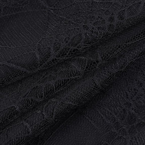 Macro view of the fine black net and web-pattern lace used in the layered tutu skirt.