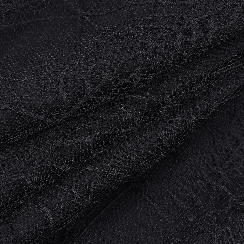 Macro view of the fine black net and web-pattern lace used in the layered tutu skirt.