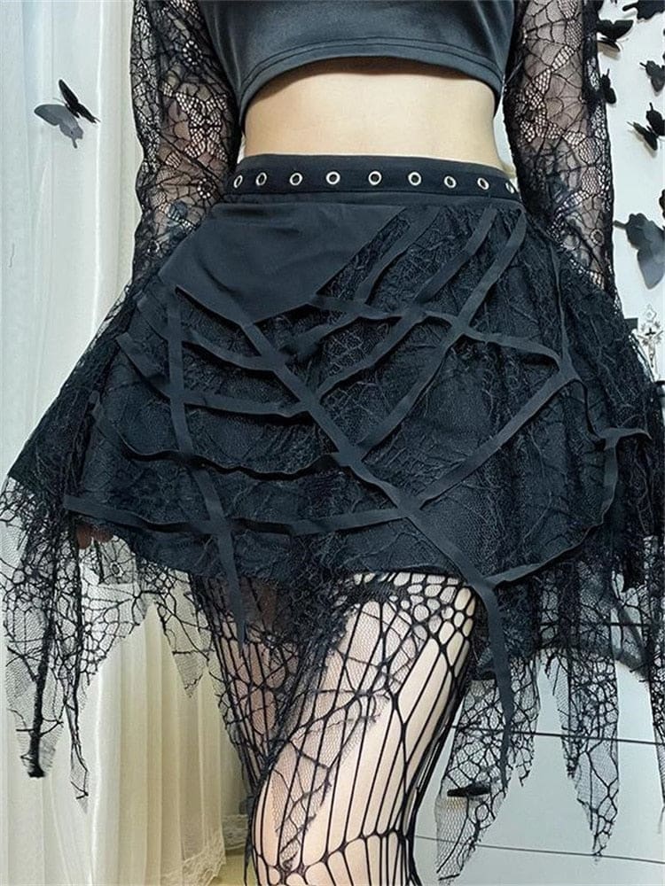 Black cobweb tutu skirt worn with a cropped top, showing cutout webs and a pointed lace hem.