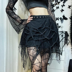 Black cobweb mini skirt styled with a fitted top, with a hand resting beside the eyelet waistband.
