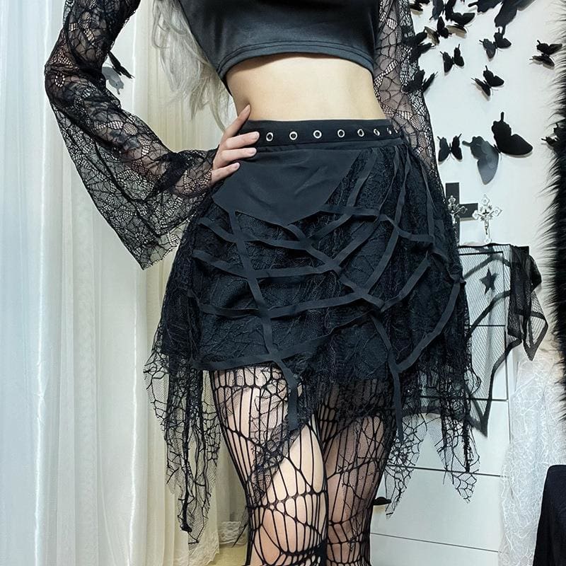 Black cobweb mini skirt styled with a fitted top, with a hand resting beside the eyelet waistband.