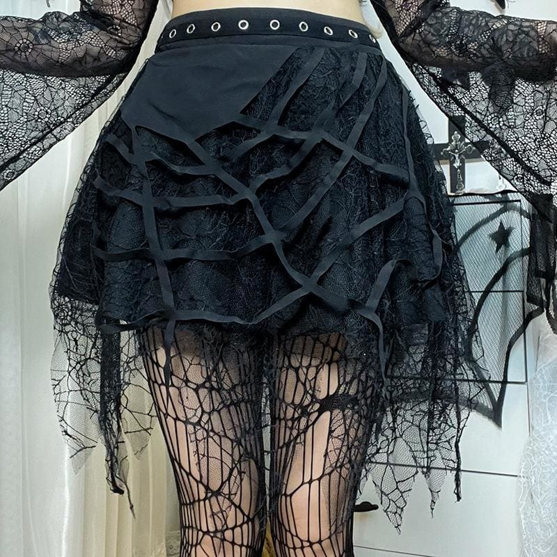 Angled view of the cutout spiderweb front on a layered black lace skirt.