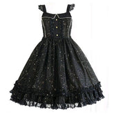 Black constellation pinafore dress displayed alone with lace-edged straps, pale bodice trim and a full ruffled skirt.