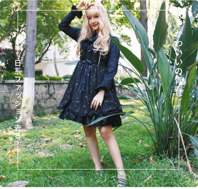 Dark celestial-print pinafore dress styled over a separate blouse outdoors among plants, with promotional text around the photo.