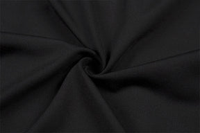 Close-up of the black cotton-blend crop top fabric gathered into folds, showing its fine knit surface.