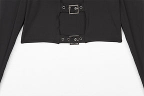 Close view of the lower front of the black crop top, with two eyelet buckle straps bridging the opening above the hem.