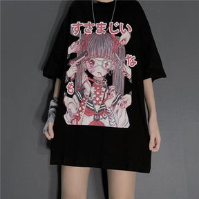 Black oversized anime T-shirt worn against a gray wall, with a large pink-and-red girl graphic and Japanese lettering. The wide short sleeves and long hem are visible above bare legs.