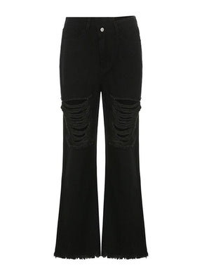 Black distressed flare jeans isolated against white, with an angled waistband, laddered front rips and full-length flared legs.