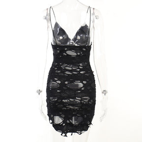 Black distressed mesh mini dress displayed from the back on a mannequin.