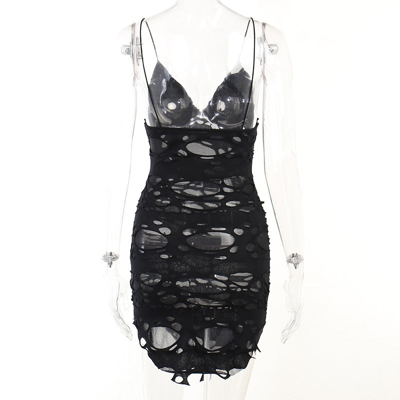 Black distressed mesh mini dress displayed from the back on a mannequin.
