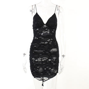 Black distressed mesh mini dress displayed from the front on a mannequin.