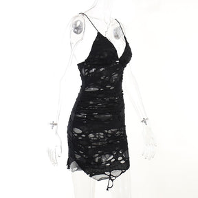 Black distressed mesh mini dress displayed in profile on a mannequin.